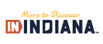 Visit Indiana logo: includes the phrase "More to Discover, IN Indiana" and has a cut out in the shape of the state of Indiana.