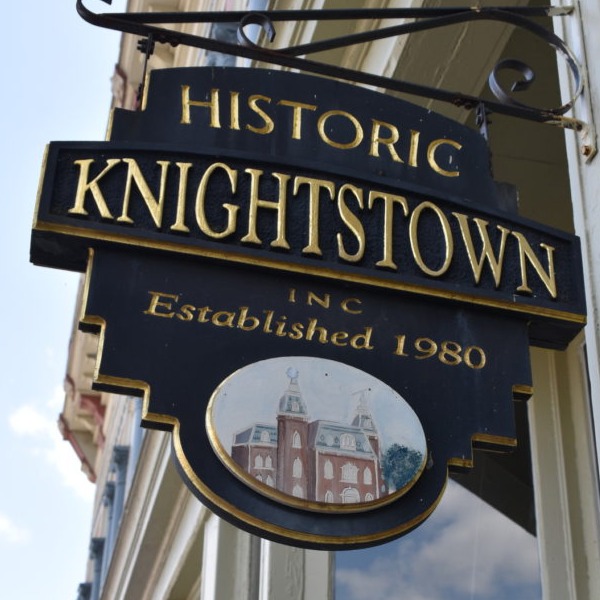 We're a new Knightstown and we're ready to welcome you to our historic district. 
Sign reading: Historic Knightstown, Inc. Established 1980